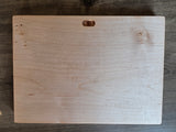 The back of a rectangular light-toned wooden sign, with a notch for hanging the sign